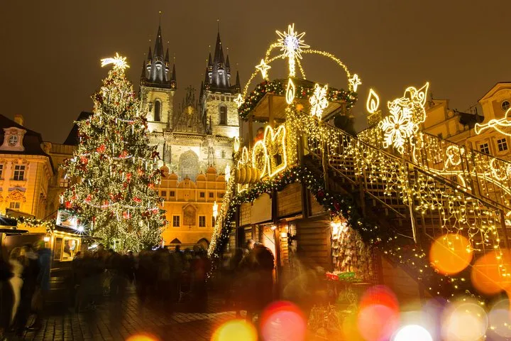 A private guide showing a family a nativity scene at a Prague Christmas market