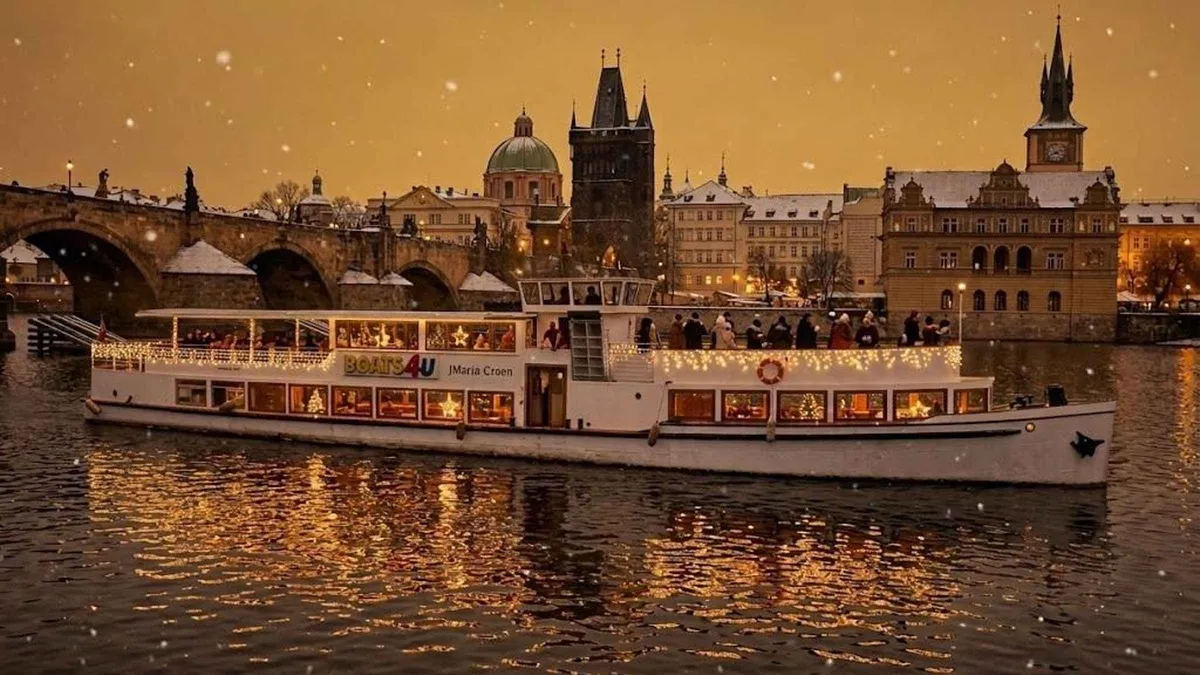 A historic river boat decorated for Advent on the Vltava in Prague at night