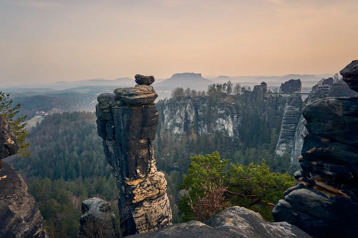 Sandstone rock pillars of the Bastei at sunrise over the Elbe Sandstone Mountains